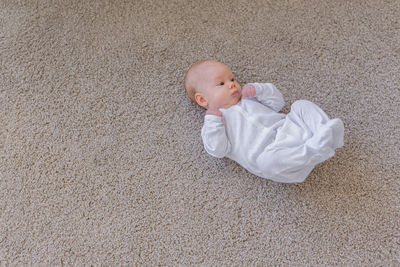 High angle view of baby girl lying on floor