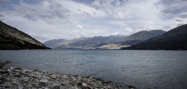 Scenic view of lake and mountains against sky