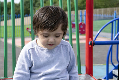 Cute boy looking at playground