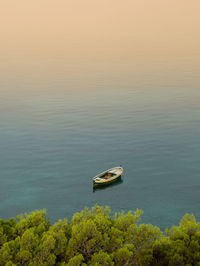 High angle view of boat moored on sea against sky