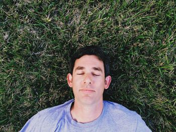 Directly above shot of man relaxing on field