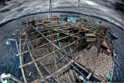 High angle view of large fishing net against cloudy sky