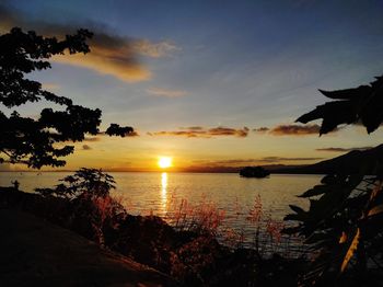 Scenic view of lake against sky during sunset