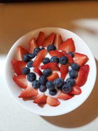 High angle view of strawberries in bowl on table