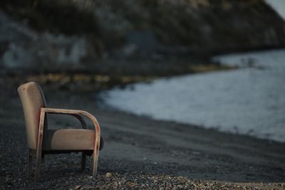 Empty chair against water