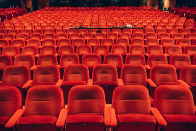 Empty red chairs in auditorium