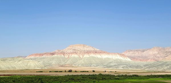 Scenic view of land against clear blue sky