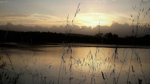 Scenic view of lake against sky during sunset