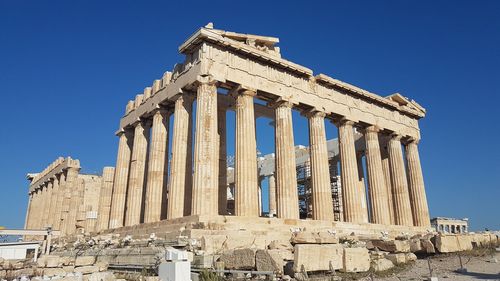 Low angle view of historical building against blue sky