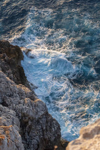 High angle view of rocks in sea