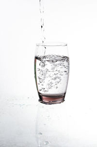 Close-up of wine glass against white background