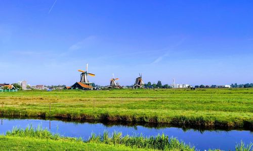 Traditional windmill on field against sky