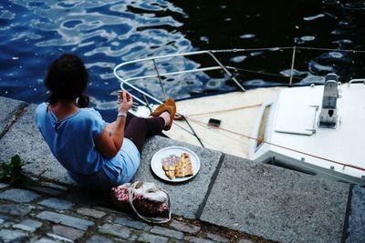 Woman eating on waterfront