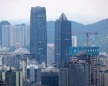 Modern buildings in city against sky