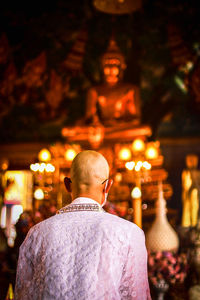 Rear view of man in temple