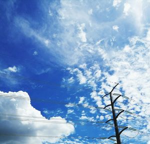 Low angle view of trees against blue sky