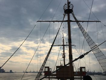 Boat on sea against cloudy sky during sunset