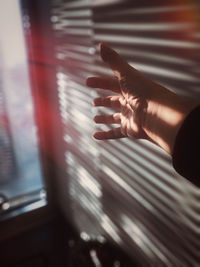 Person playing piano seen through window