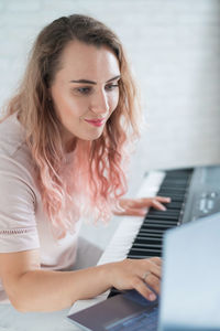 Young woman using laptop at home