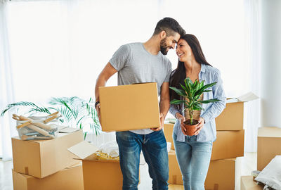 Young couple holding hands in box