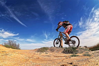 Man riding bicycle on field