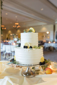 Close-up of wedding cake on stand at table