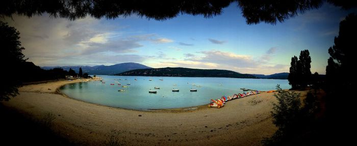 Panoramic view of beach against sky during sunset