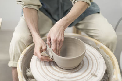 Midsection of man working at workshop