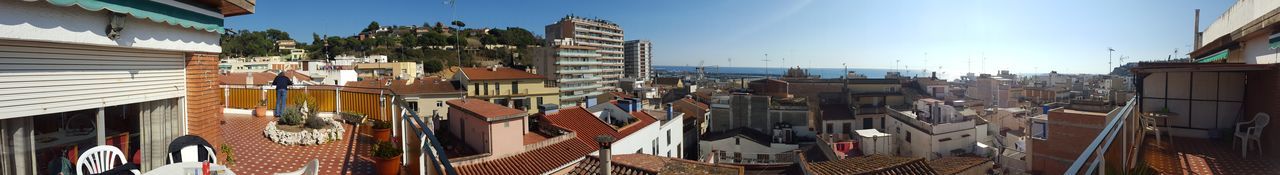 Panoramic view of houses in town against sky