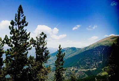 Scenic view of mountains against blue sky