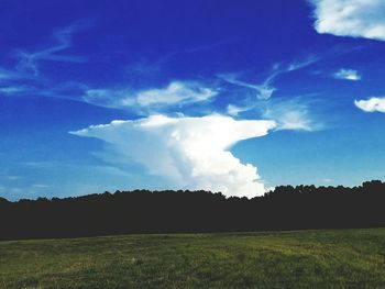 Scenic view of landscape against blue sky