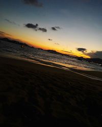 Scenic view of beach against sky during sunset