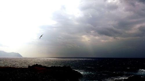 Scenic view of sea against cloudy sky