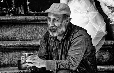 Thoughtful man sitting on steps