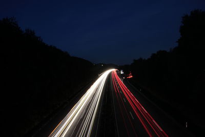 High angle view of light trails on road at night