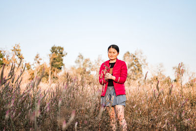 Portrait of happy girl standing on field