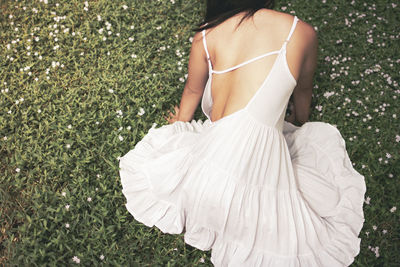 Rear view of a woman standing on grass