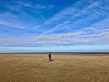 Woman on beach against sky