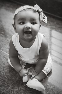 High angle view of cute girl sitting on floor