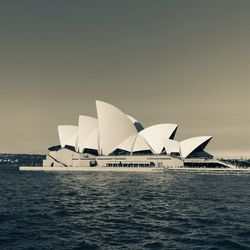 Built structure in sea against clear sky