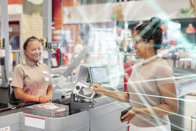 Woman paying with card in store