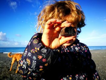 Full length of woman at beach against sky