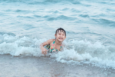 Young child girl swimming in sea