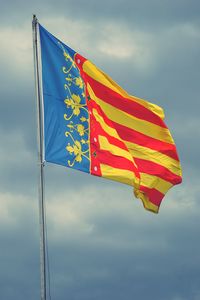 Low angle view of flag against sky