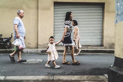 Full length of father with daughter in city