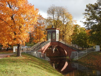 Arch bridge over canal against sky during autumn