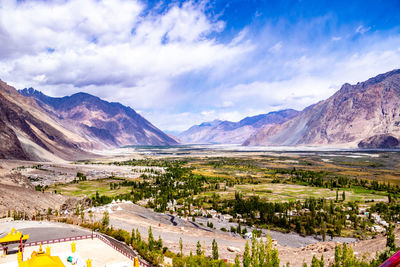 Scenic view of landscape and mountains against sky