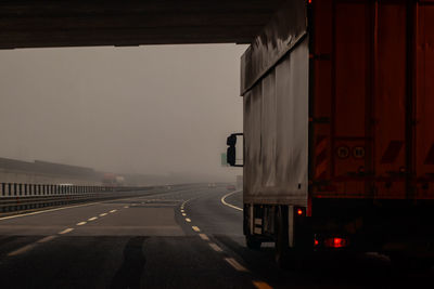 Vehicles on road against sky