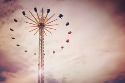 Low angle view of ferris wheel against sky