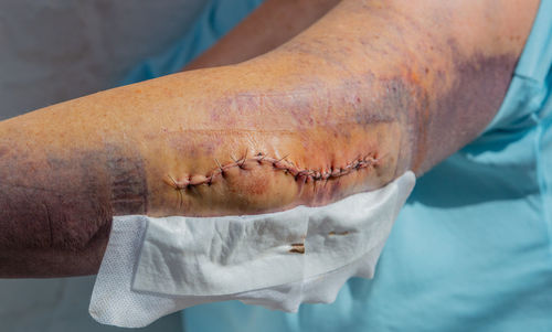 Cropped hand of man holding dentures